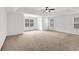 Spacious bedroom featuring tray ceiling and carpet, with three windows for ample lighting at 4945 Racquet Ct, Duluth, GA 30096