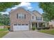 Charming two-story brick home with a well-maintained lawn and attached two car garage at 4945 Racquet Ct, Duluth, GA 30096