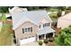 Charming two-story brick home featuring a covered front porch and attached two-car garage at 4945 Racquet Ct, Duluth, GA 30096
