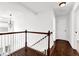 Hallway showcasing wood floors and white stair railing at 4945 Racquet Ct, Duluth, GA 30096