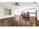 Kitchen and living room area with hardwood floors, a ceiling fan, and a white kitchen with an island at 4945 Racquet Ct, Duluth, GA 30096