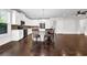 Open kitchen featuring white cabinets, stainless appliances, a center island, and hardwood floors at 4945 Racquet Ct, Duluth, GA 30096