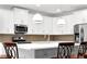 Bright modern kitchen featuring white cabinets, stainless appliances, and pendant lighting over a center island at 4945 Racquet Ct, Duluth, GA 30096