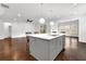 Kitchen island with white countertop and light gray cabinets overlooks the dining and living areas at 4945 Racquet Ct, Duluth, GA 30096
