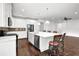 Bright white kitchen with stainless steel appliances, a large island, and modern pendant lighting at 4945 Racquet Ct, Duluth, GA 30096