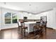 Bright kitchen with white cabinets, stainless steel appliances, island with seating, and hardwood floors at 4945 Racquet Ct, Duluth, GA 30096
