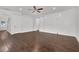 Open living room featuring hardwood floors, a ceiling fan, and a sliding barn door to another room at 4945 Racquet Ct, Duluth, GA 30096