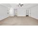 Large main bedroom with ceiling fan, carpet, and view into ensuite bathroom at 4945 Racquet Ct, Duluth, GA 30096
