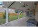 Spacious covered patio with ceiling fans overlooks a well-manicured backyard at 4945 Racquet Ct, Duluth, GA 30096