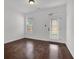 Empty room with hardwood floors, a rear door, and a window overlooking the backyard at 4945 Racquet Ct, Duluth, GA 30096