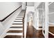 A wooden staircase with white risers leads to the second floor at 4945 Racquet Ct, Duluth, GA 30096