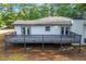 Exterior shot of deck showing dark railings and stairs to backyard at 1377 Hill Sw Dr, Conyers, GA 30094