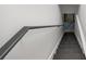Basement staircase with a metal handrail leading to the basement at 1377 Hill Sw Dr, Conyers, GA 30094