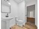Bathroom with a pedestal sink, toilet, and ceramic tile flooring at 1377 Hill Sw Dr, Conyers, GA 30094