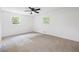Carpeted bedroom with a ceiling fan and natural light at 1377 Hill Sw Dr, Conyers, GA 30094