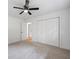 Neutral bedroom with a modern ceiling fan, and a double door closet at 1377 Hill Sw Dr, Conyers, GA 30094