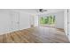 Light filled bedroom with hardwood flooring and large windows showcasing wooded back yard at 1377 Hill Sw Dr, Conyers, GA 30094