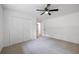 Neutral bedroom with a modern ceiling fan, closet, and access to hallway at 1377 Hill Sw Dr, Conyers, GA 30094