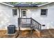Exterior view of a home featuring a newly painted back porch and updated windows at 1377 Hill Sw Dr, Conyers, GA 30094