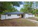 Single-story home with white brick, black trim, and a well-manicured lawn at 1377 Hill Sw Dr, Conyers, GA 30094