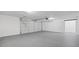View of the spacious two car garage with painted floor and automatic door at 1377 Hill Sw Dr, Conyers, GA 30094