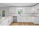 Contemporary kitchen featuring granite countertops, stainless steel appliances, white cabinets, and a scenic window view at 1377 Hill Sw Dr, Conyers, GA 30094