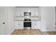 Bright kitchen featuring white cabinets, stainless steel appliances, and granite countertops at 1377 Hill Sw Dr, Conyers, GA 30094