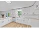 Modern kitchen showcases sleek white cabinets, granite counters, stainless steel appliances, and natural light at 1377 Hill Sw Dr, Conyers, GA 30094