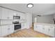 Modern kitchen boasts stainless appliances, granite counters, sleek cabinetry, and a view into the living area at 1377 Hill Sw Dr, Conyers, GA 30094