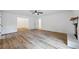 Open-concept living area featuring wood floors, white walls, and views into other rooms with multiple entry points at 1377 Hill Sw Dr, Conyers, GA 30094