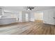 Bright open living space showcasing wood flooring, a ceiling fan, and an open-concept design leading to the kitchen at 1377 Hill Sw Dr, Conyers, GA 30094
