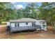 View of the back of the house with large deck and manicured lawn at 1377 Hill Sw Dr, Conyers, GA 30094
