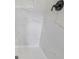 Close-up of updated tiled shower with modern fixtures and hardware at 1377 Hill Sw Dr, Conyers, GA 30094