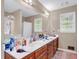 Bright bathroom with a double vanity, and large mirror and windows at 1574 Glenfield Dr, Lawrenceville, GA 30043