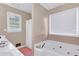 Bright bathroom with a double vanity, and jetted tub with jets at 1574 Glenfield Dr, Lawrenceville, GA 30043