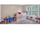 Cozy carpeted bedroom with a pull-out trundle bed and natural light at 1574 Glenfield Dr, Lawrenceville, GA 30043