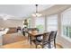 Dining room with modern chandelier, hardwood floors, and lots of natural light at 1574 Glenfield Dr, Lawrenceville, GA 30043