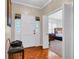 Inviting foyer featuring hardwood floors, a stylish bench, and a view into a bedroom at 1574 Glenfield Dr, Lawrenceville, GA 30043