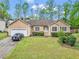 Charming single Gathering home showcasing a lush front yard, attached garage and inviting curb appeal at 1574 Glenfield Dr, Lawrenceville, GA 30043