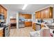 Spacious kitchen with stainless steel refrigerator, wood cabinets, and a view into the bedroom at 1574 Glenfield Dr, Lawrenceville, GA 30043