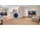 Open-concept living room with a small trampoline, and a view to the adjacent kitchen at 1574 Glenfield Dr, Lawrenceville, GA 30043