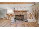 Finished basement with a striking brick fireplace, wood floors, and rustic decor elements at 2095 Gherry Dr, Austell, GA 30106