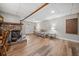Cozy basement featuring a brick fireplace, wood-look flooring, and a quaint daybed seating area at 2095 Gherry Dr, Austell, GA 30106