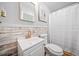 A bright bathroom featuring a white sink, wood-paneled wall, and a white shower curtain at 2095 Gherry Dr, Austell, GA 30106
