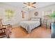 Bright bedroom featuring wood floors, ceiling fan, rocking chair and decorative accents at 2095 Gherry Dr, Austell, GA 30106