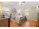 Bright bedroom featuring wood floors, ceiling fan, rocking chair and decorative accents at 2095 Gherry Dr, Austell, GA 30106