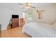 A bedroom with a ceiling fan, a wood dresser, and a white bed at 2095 Gherry Dr, Austell, GA 30106