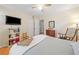 Bright bedroom featuring wood floors, ceiling fan, a TV, and decorative accents at 2095 Gherry Dr, Austell, GA 30106