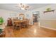 A dining room with wood flooring, wood table and chairs, an overhead fan, and an open entrance to the kitchen at 2095 Gherry Dr, Austell, GA 30106