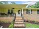 Charming front porch with brick steps, rocking chairs, and manicured landscaping at 2095 Gherry Dr, Austell, GA 30106